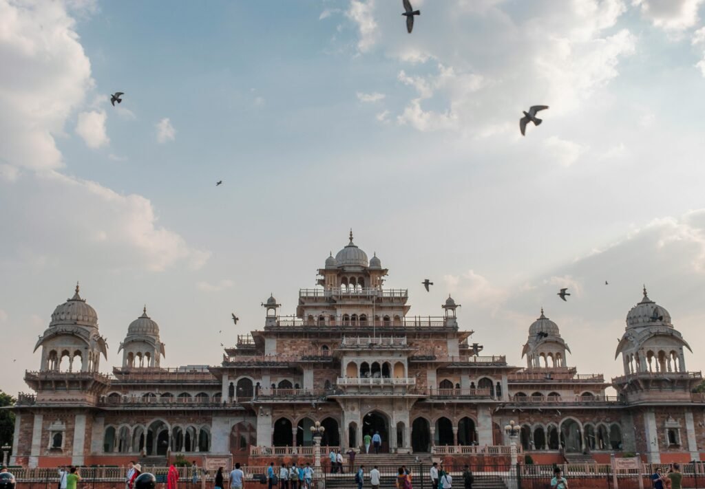 Stunning view of the historic Albert Hall Museum in Jaipur with birds flying above.